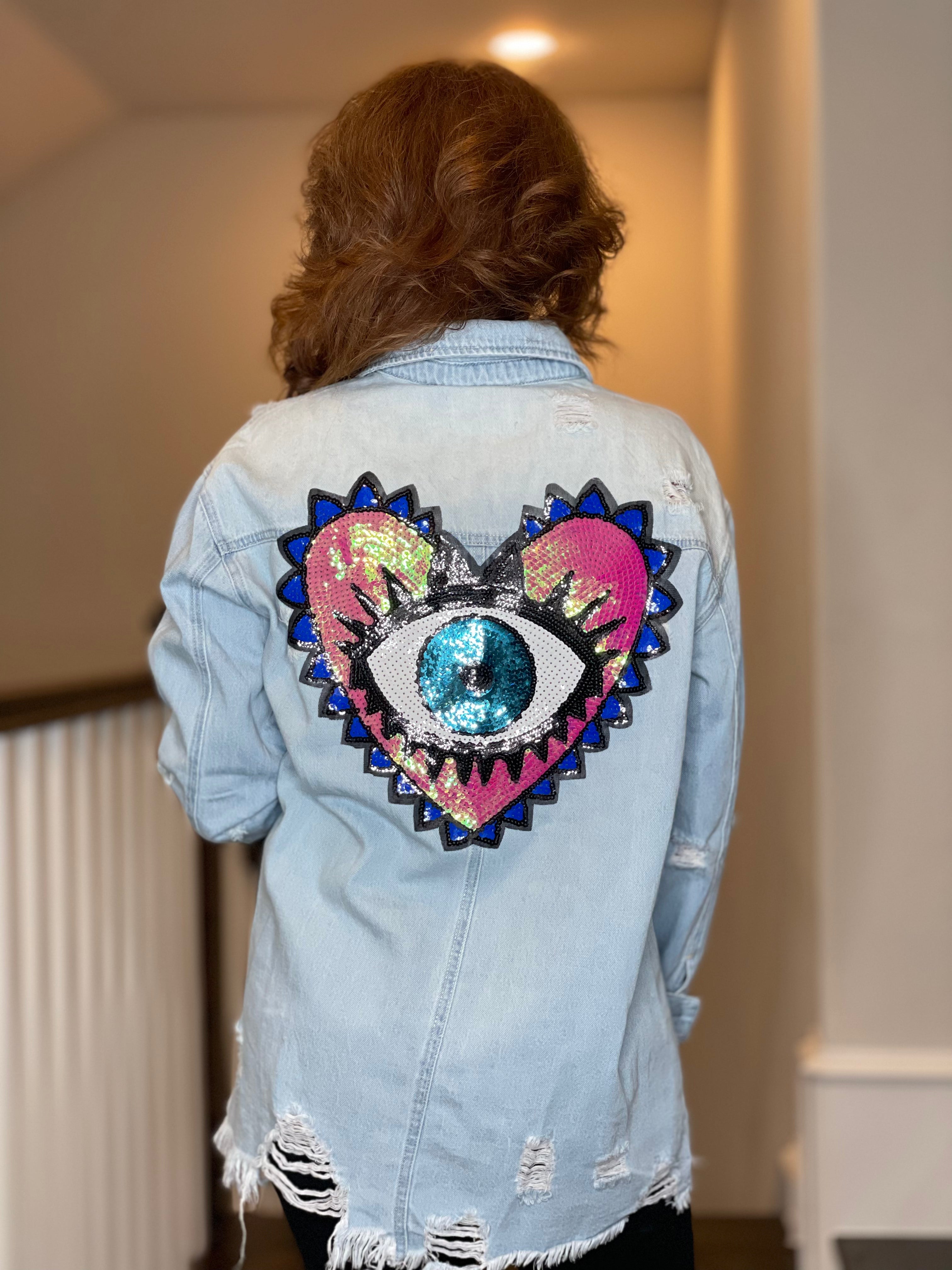Distressed Denim Shacket with Evil Eye Heart Embellishment.