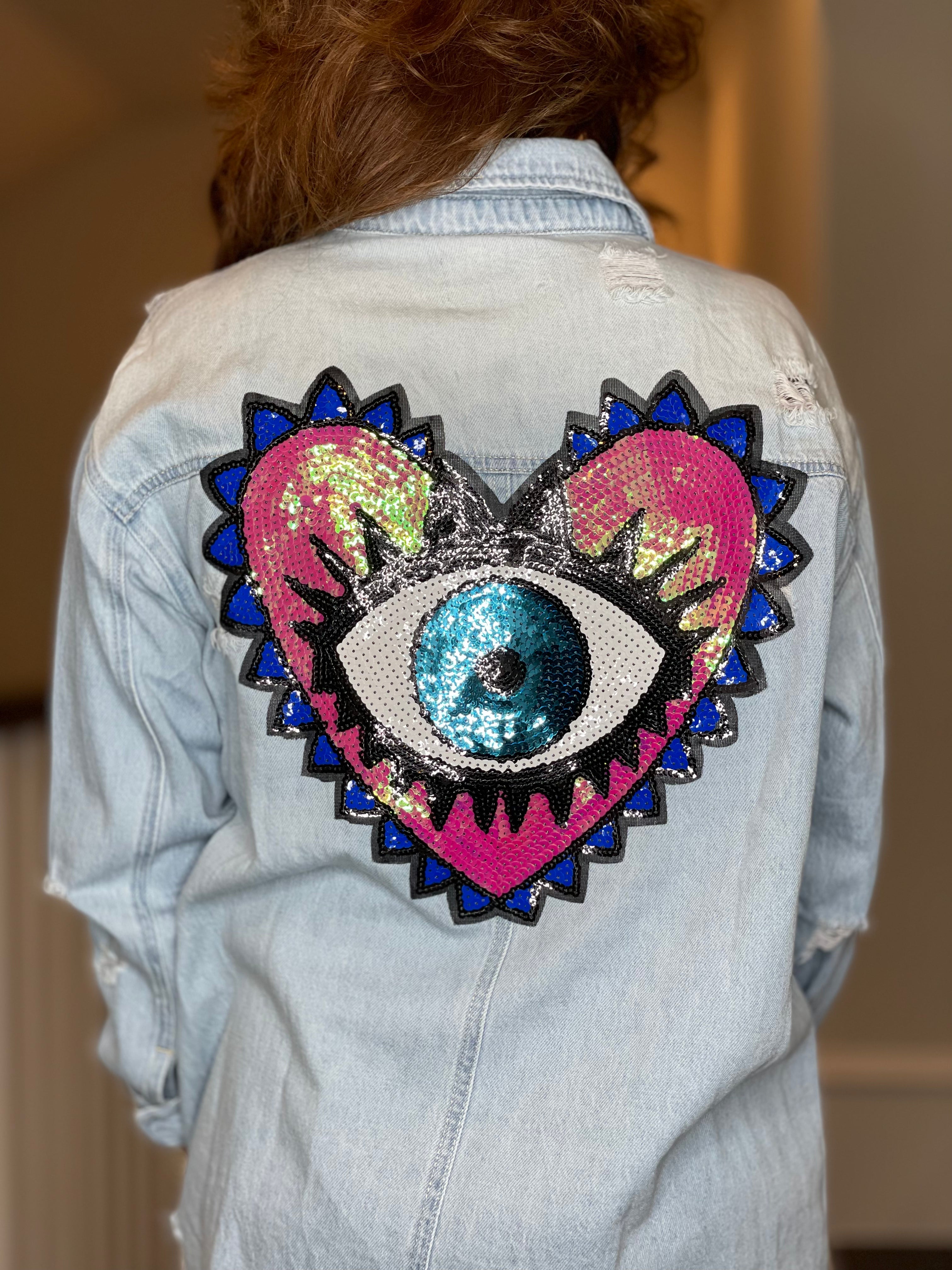 Distressed Denim Shacket with Evil Eye Heart Embellishment.