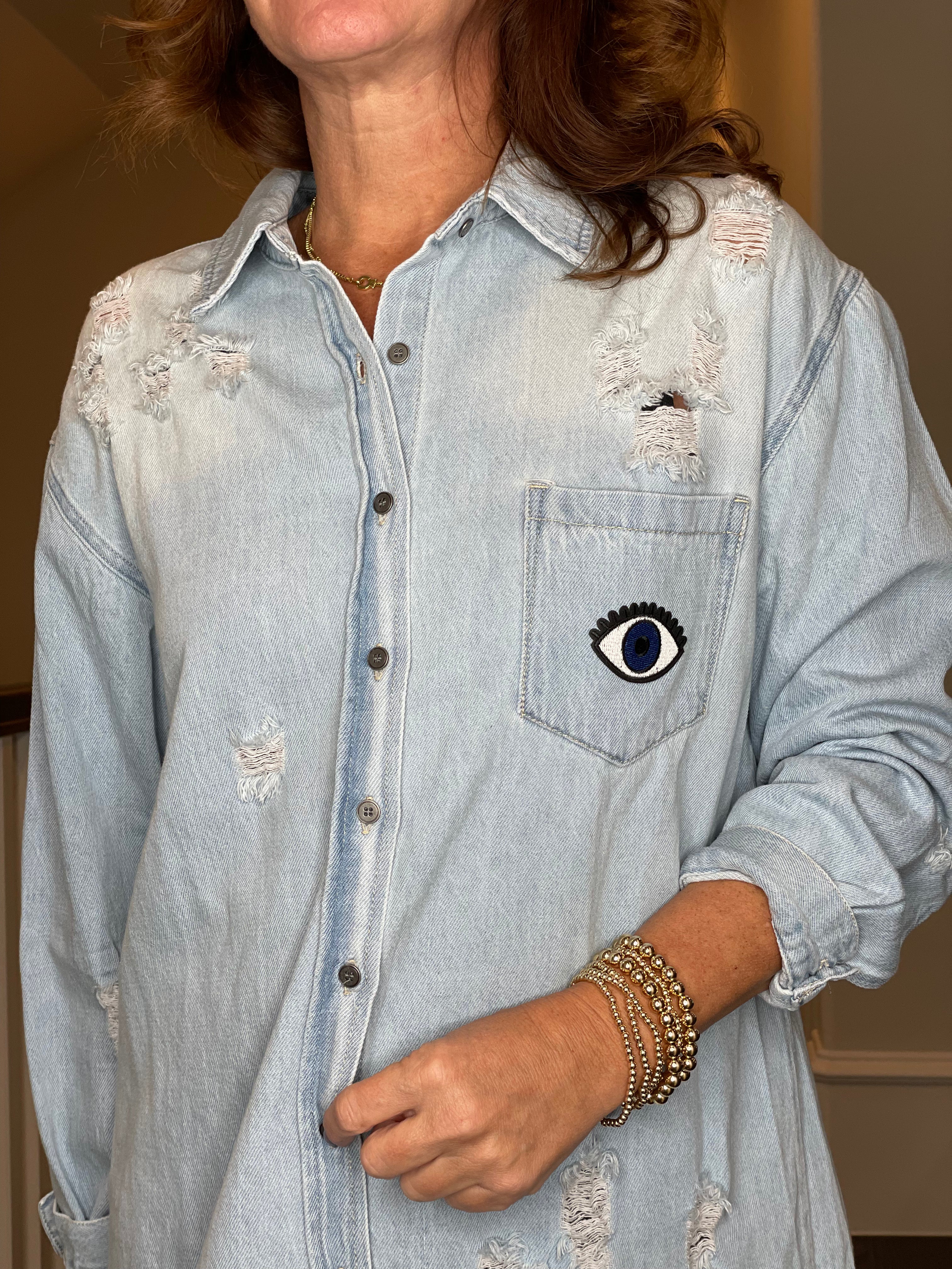 Distressed Denim Shacket with Evil Eye Heart Embellishment.
